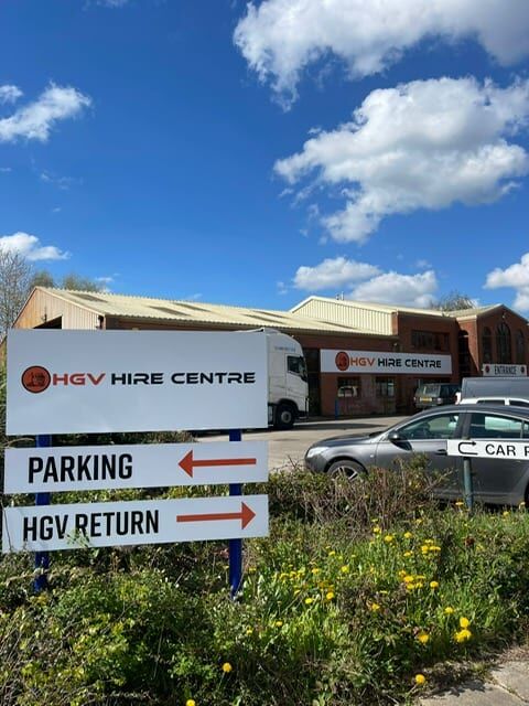 The HGV Hire Centre sign at the depot entrance, pointing to parking and HGV return